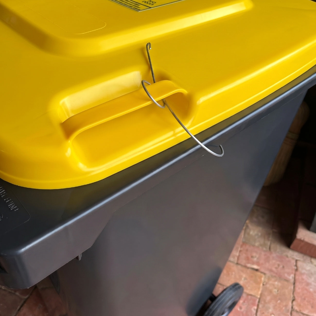 Bin Clip fitted to household wheelie bins to keep rubbish secure between collections. FREE Australia wide shipping.
